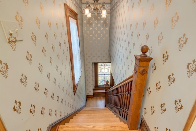 645 Hughes St, Cape May, NJ 08204 - staircase with wood finished floors, a chandelier, and wallpapered walls