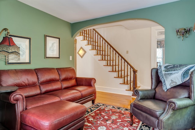 645 Hughes St, Cape May, NJ 08204 - living room featuring arched walkways, stairs, and wood finished floors