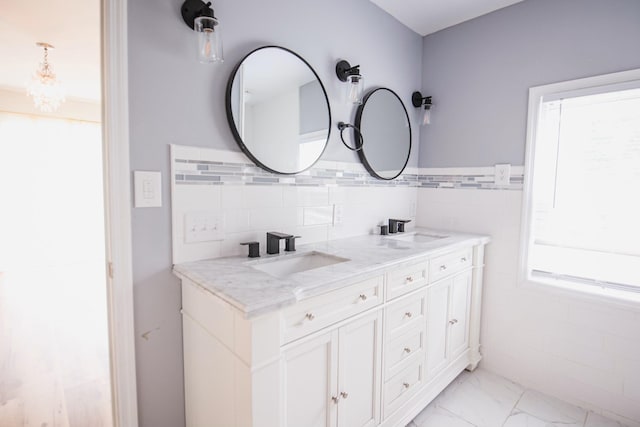 bathroom featuring vanity and tile walls