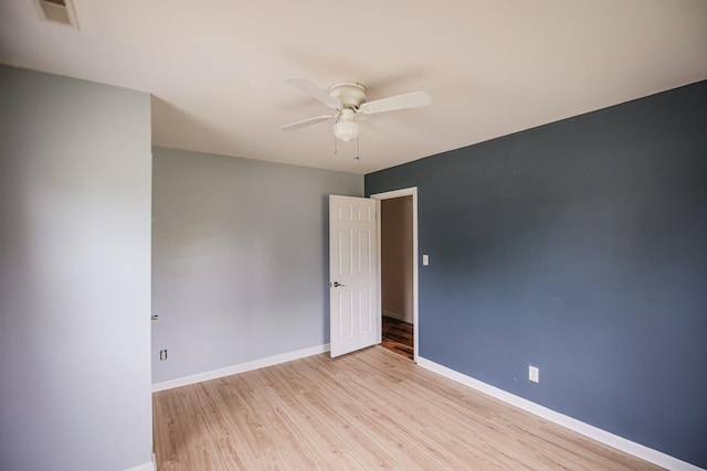 spare room with light hardwood / wood-style floors and ceiling fan