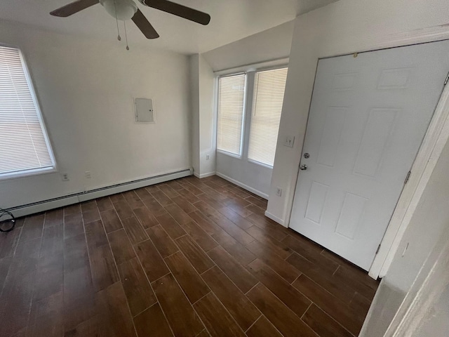 foyer entrance with electric panel, ceiling fan, and a baseboard heating unit