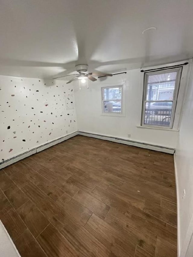 spare room with ceiling fan, dark hardwood / wood-style flooring, and a baseboard radiator