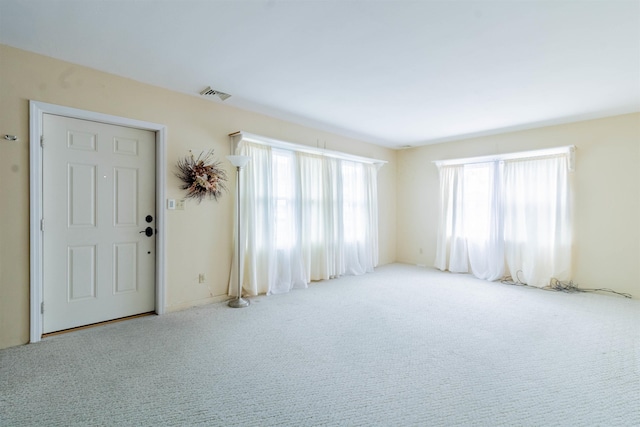 interior space featuring visible vents and carpet flooring