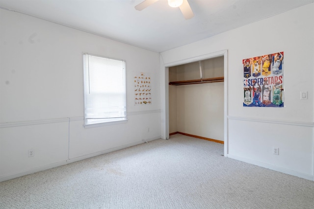unfurnished bedroom with baseboards, a ceiling fan, carpet flooring, and a closet
