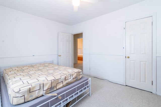 bedroom featuring a ceiling fan and light colored carpet