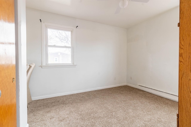 carpeted empty room featuring a baseboard heating unit, ceiling fan, and baseboards