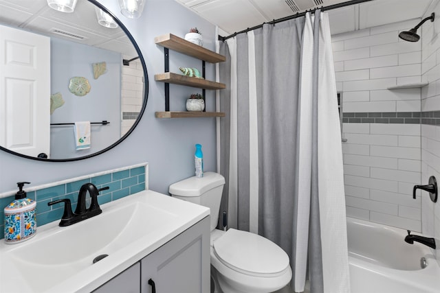 bathroom featuring visible vents, toilet, vanity, shower / tub combo with curtain, and tasteful backsplash
