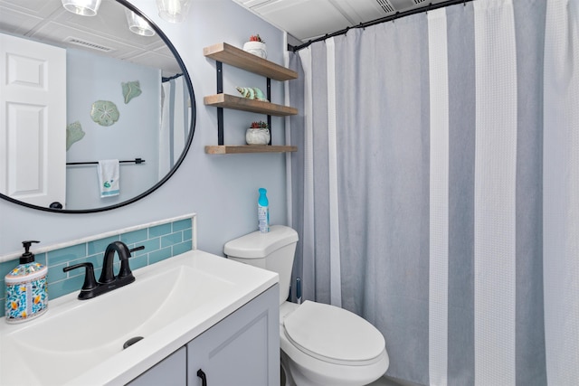 bathroom with backsplash, visible vents, toilet, and vanity