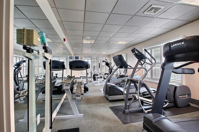 exercise room featuring a paneled ceiling and visible vents