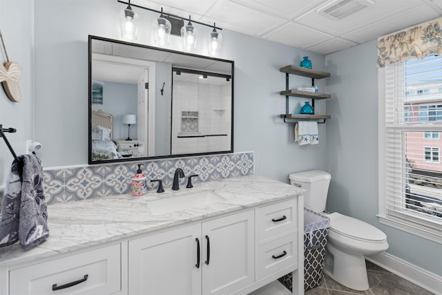 bathroom with visible vents, toilet, vanity, connected bathroom, and tasteful backsplash
