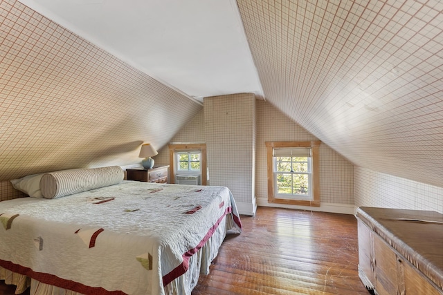 bedroom featuring baseboards, dark wood-style floors, and lofted ceiling