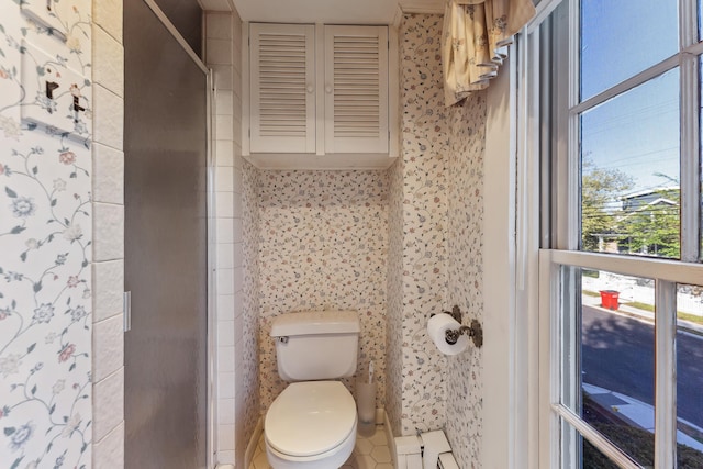 full bathroom with toilet and a shower stall
