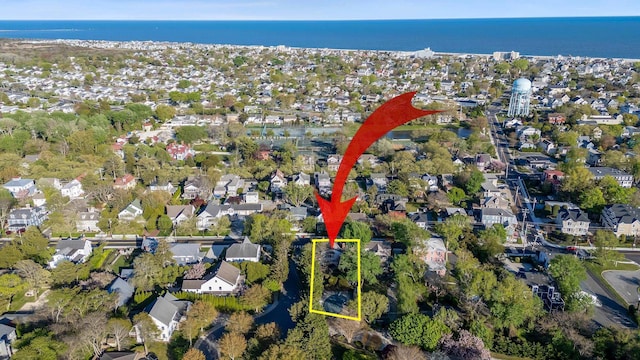 birds eye view of property featuring a water view and a residential view