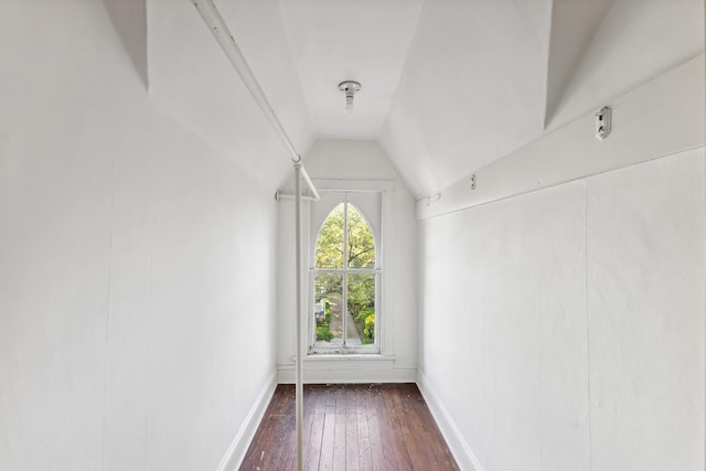 additional living space featuring baseboards, dark wood-style flooring, and lofted ceiling