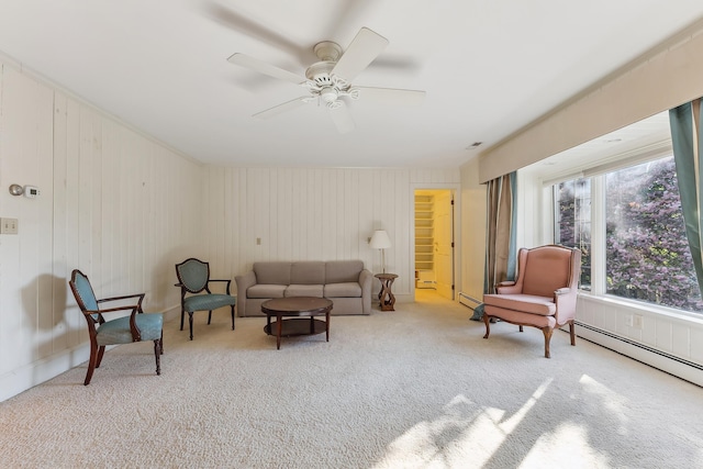 living area with ceiling fan, carpet, a baseboard heating unit, and visible vents
