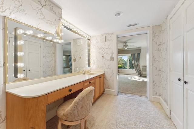 bathroom with a ceiling fan, visible vents, vanity, baseboards, and wallpapered walls