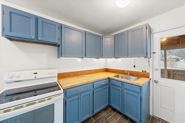 kitchen with blue cabinetry, sink, electric range, and a textured ceiling