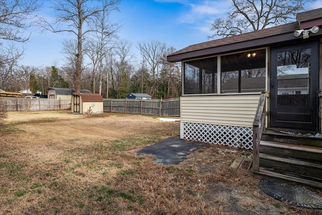 view of yard featuring a storage shed and a sunroom