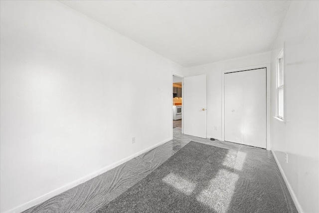 unfurnished bedroom featuring carpet floors and a closet