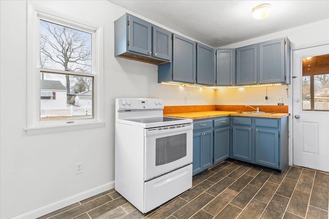 kitchen with sink, a wealth of natural light, white electric stove, and blue cabinets