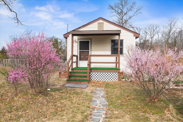 bungalow-style home featuring a front yard