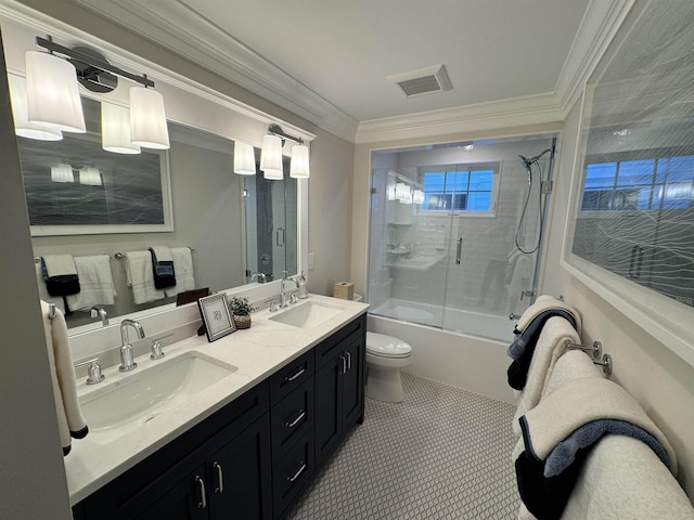 full bathroom with vanity, tile patterned floors, crown molding, toilet, and enclosed tub / shower combo