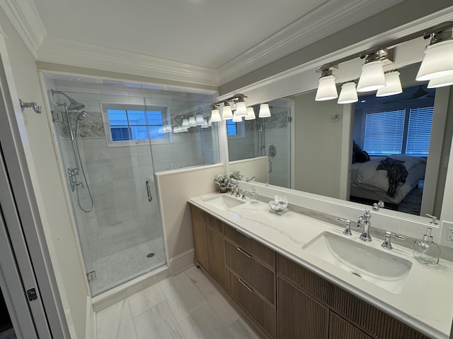 bathroom with vanity, a shower with shower door, and ornamental molding