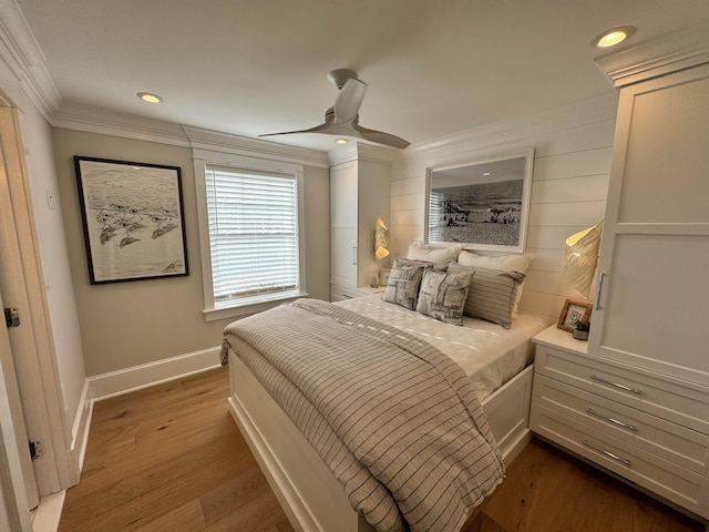 bedroom with wood-type flooring, ceiling fan, and crown molding