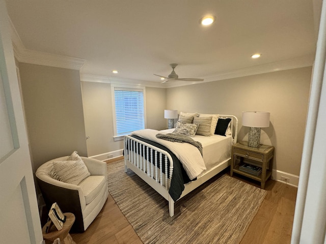 bedroom featuring hardwood / wood-style flooring, ceiling fan, and crown molding