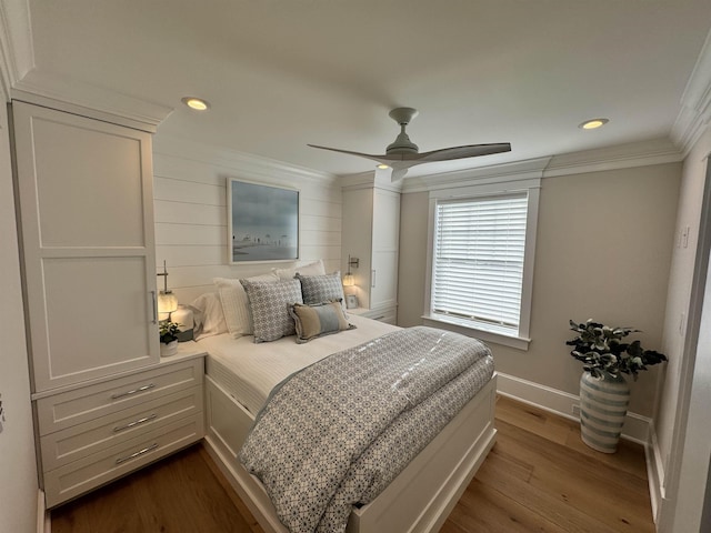 bedroom featuring ceiling fan, wood-type flooring, and crown molding