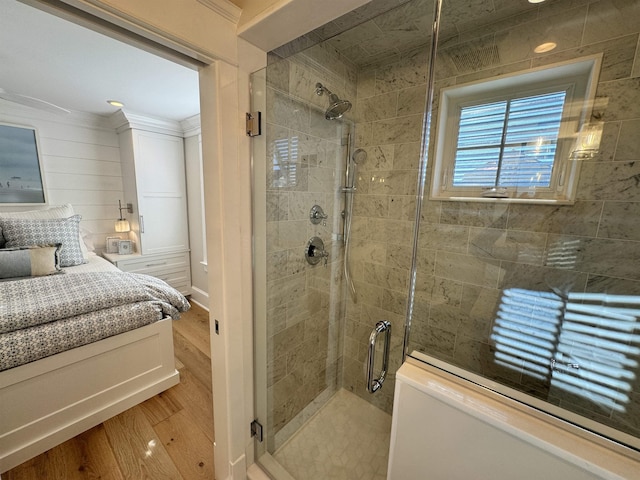 bathroom featuring hardwood / wood-style floors and a shower with door