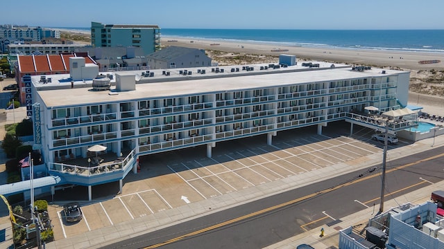 aerial view with a water view and a view of the beach