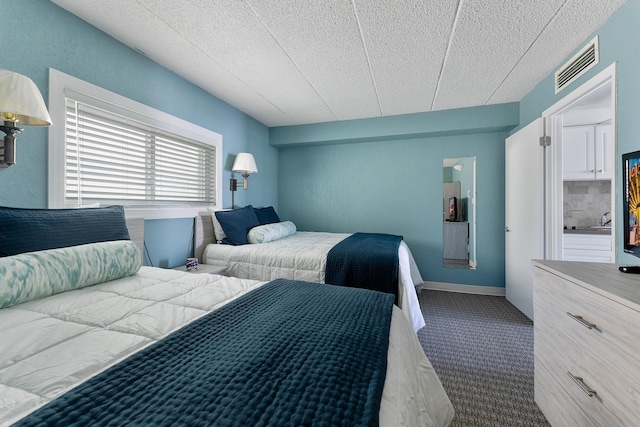 bedroom with visible vents and baseboards