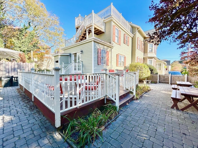 rear view of property with a patio area and a wooden deck