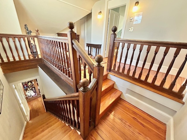 stairs featuring hardwood / wood-style floors