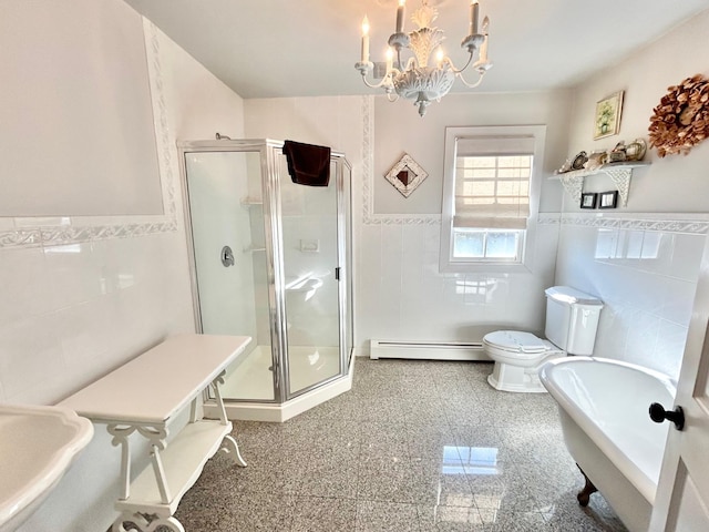 bathroom featuring a chandelier, toilet, and tile walls