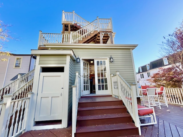 back of house with a wooden deck and french doors