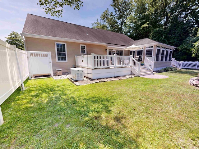 63 Cape Woods Rd, North Cape May, NJ 08204 - rear view of property featuring a sunroom, a wooden deck, a fenced backyard, and a shingled roof