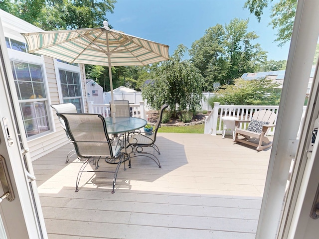 63 Cape Woods Rd, North Cape May, NJ 08204 - wooden terrace with a storage unit and outdoor dining area