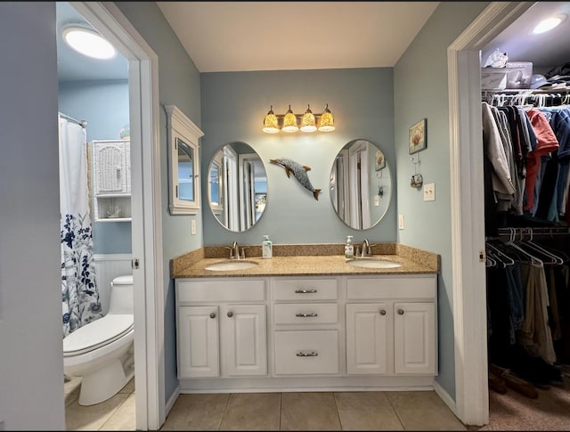 63 Cape Woods Rd, North Cape May, NJ 08204 - full bathroom featuring tile patterned floors, double vanity, a walk in closet, and a shower with shower curtain