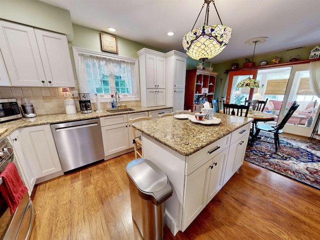 63 Cape Woods Rd, North Cape May, NJ 08204 - kitchen with stainless steel appliances, light wood-style floors, a kitchen island, recessed lighting, and decorative light fixtures
