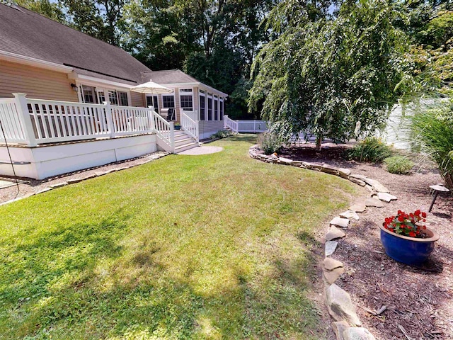 63 Cape Woods Rd, North Cape May, NJ 08204 - view of green lawn with a sunroom and a deck