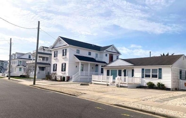 view of front of house with a residential view and a porch