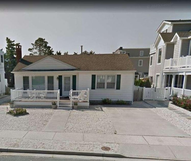 view of front of property with a chimney and a porch