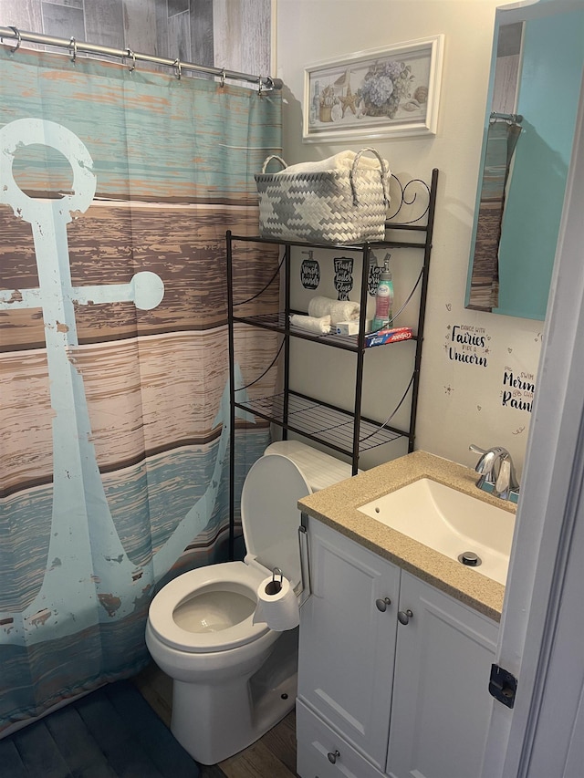 bathroom with vanity, curtained shower, toilet, and wood-type flooring