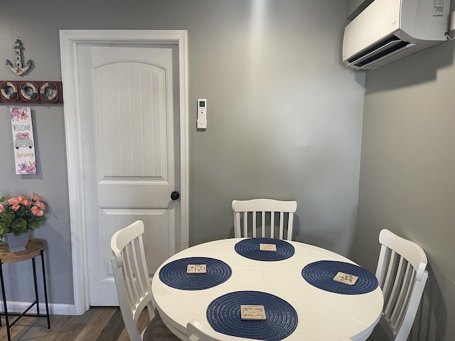 dining space with a wall unit AC and dark hardwood / wood-style flooring