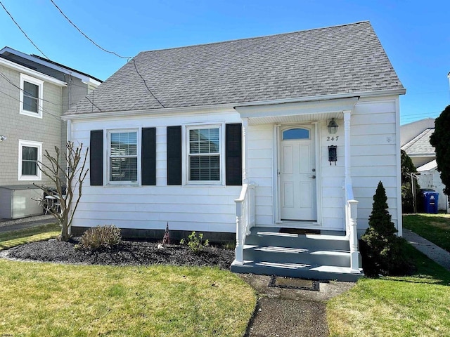 bungalow-style home with a front yard