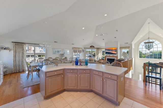 7423 Ocean Dr, Avalon, NJ 08202 - kitchen featuring a chandelier, vaulted ceiling, light countertops, open floor plan, and hanging light fixtures