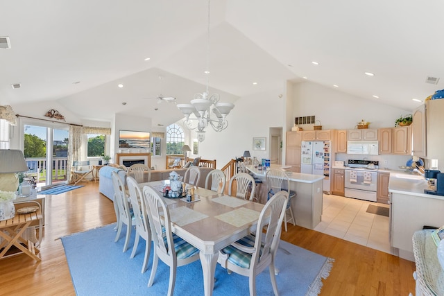 7423 Ocean Dr, Avalon, NJ 08202 - dining area featuring a fireplace, light wood-type flooring, high vaulted ceiling, a chandelier, and recessed lighting