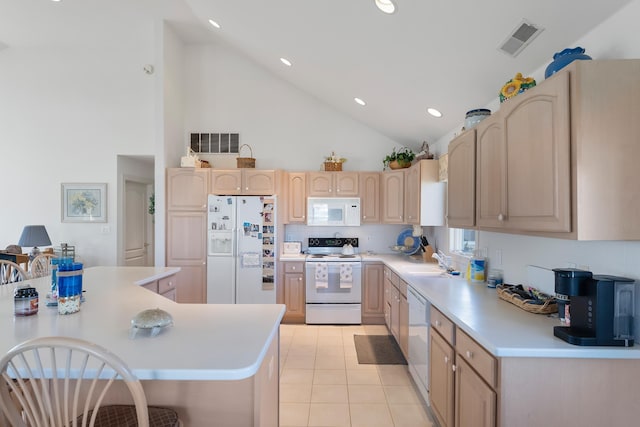 7423 Ocean Dr, Avalon, NJ 08202 - kitchen featuring white appliances, light brown cabinets, a sink, light countertops, and high vaulted ceiling